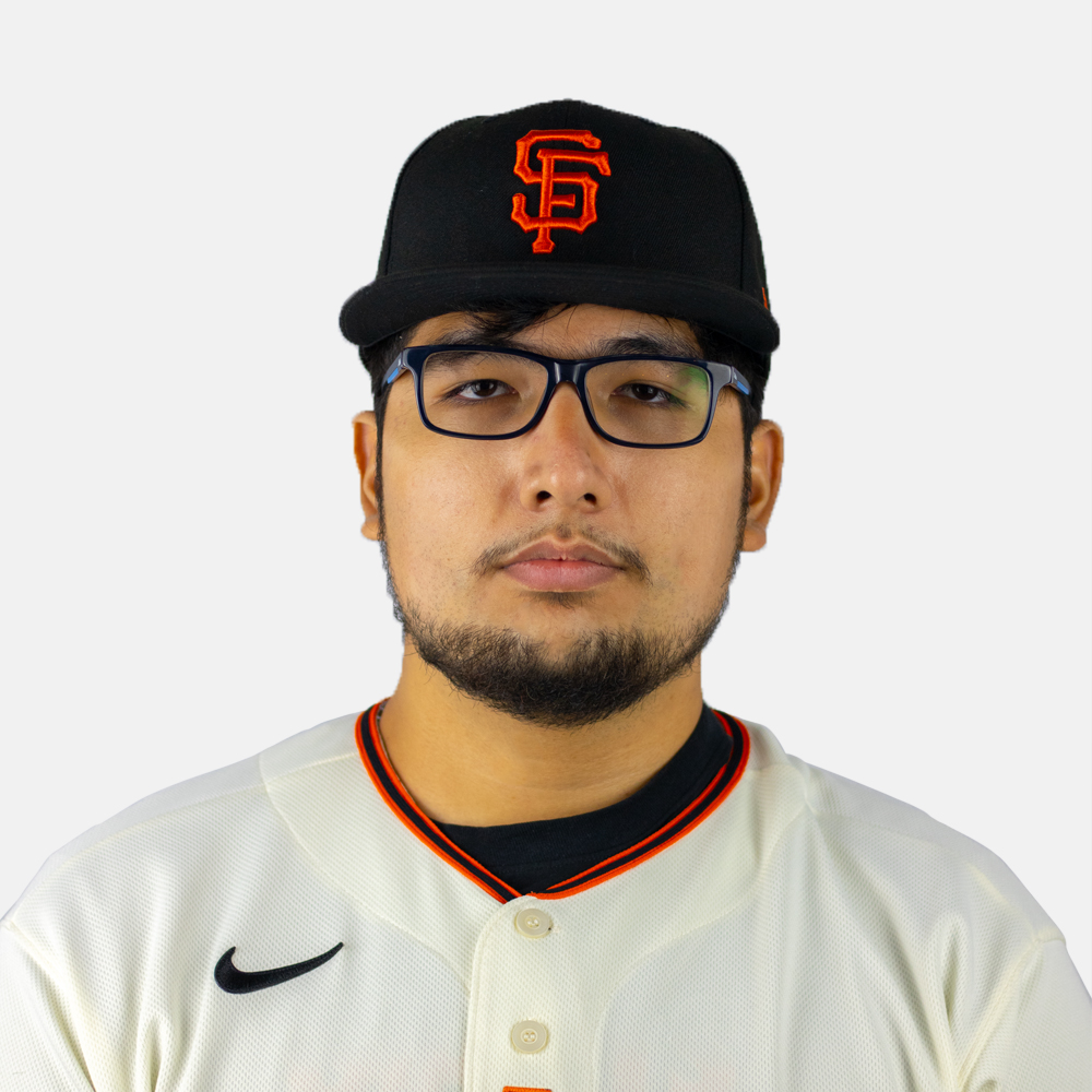 Latino man with short dark hair wearing glasses and a hat.